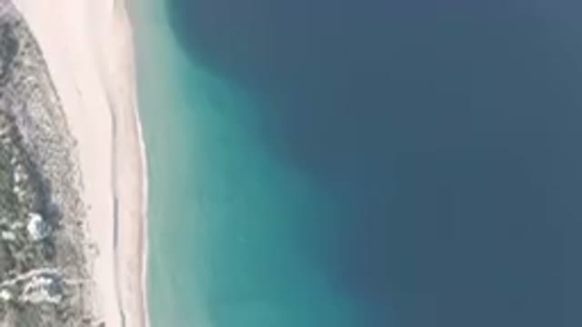 LOS FRAILES BCS MEXICO-2023: Flying Over A Beach With A Blue Ocean And A White