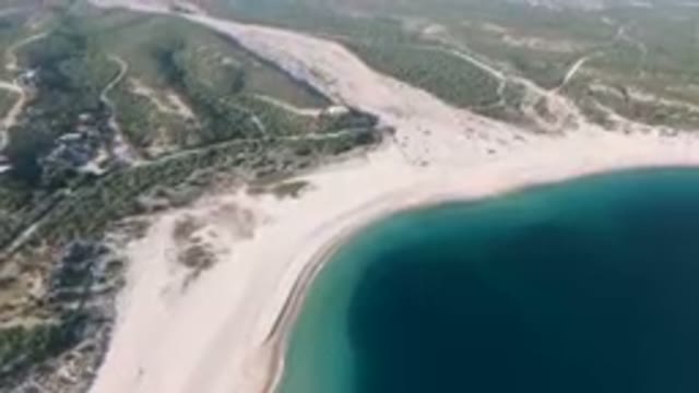 LOS FRAILES BCS MEXICO-2023: Aerial Beach And A Body Of Water With A Mountain In