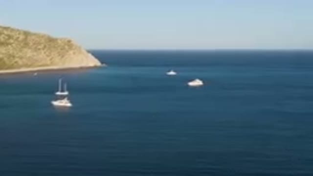 LOS FRAILES BCS MEXICO-2023: Several Boats Are In The Water Near A Mountain And