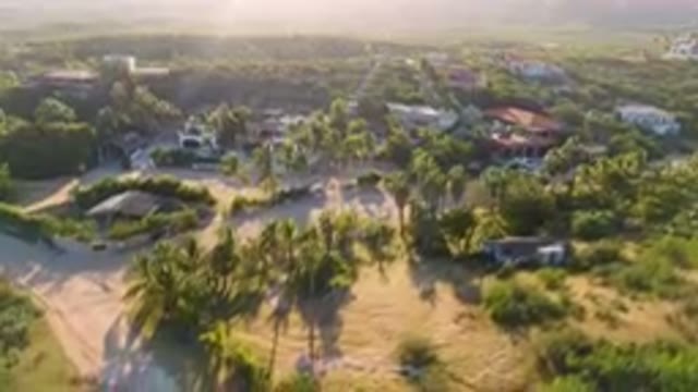 LOS FRAILES BCS MEXICO-2023: Aerial Small Town Surrounded By Palm Trees And Hills