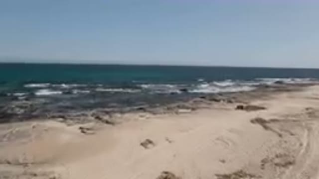 SHIPWRECKS BEACH LOS CABOS BCS MEXICO-2023: Man Standing On A Rock Looking Out