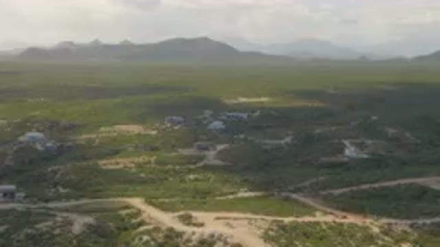 SHIPWRECKS BEACH LOS CABOS BCS MEXICO-2023: Aerial Small Town In The Middle Of A Green Valley