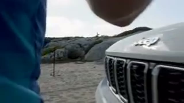 SHIPWRECKS BEACH LOS CABOS BCS MEXICO-2023: Car Parked on Beach with Person Standing