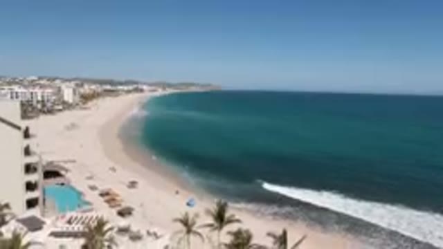 COSTA AZUL LOS CABOS BCS MEXICO-2023: Beach With Palm Trees And A Hotel