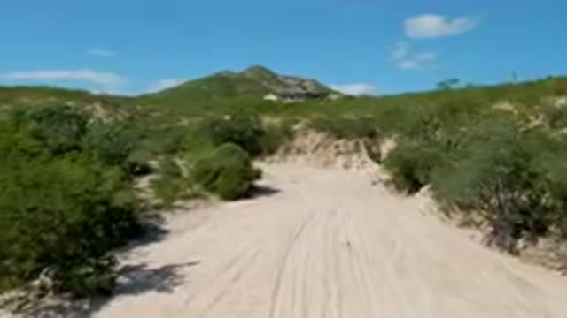 CABO PULMO BCS MEXICO-2023: Dirt Road With A House On The Hill In The Background