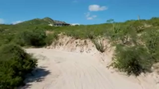 CABO PULMO BCS MEXICO-2023: Dirt Road With A House On A Hill In The Background