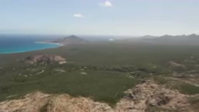 CABO PULMO BCS MEXICO-2023: Green Landscape With A Blue Ocean And Mountains