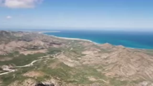 CABO PULMO BCS MEXICO-2023: Mountain Range With A Winding Road And A Body Of Water