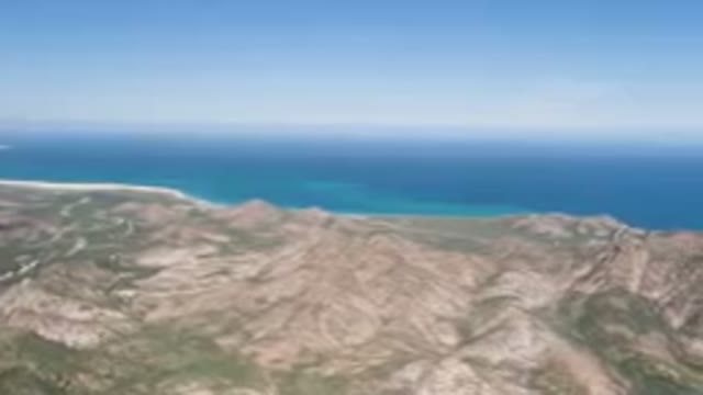 CABO PULMO BCS MEXICO-2023: Mountain Range With A Body Of Water In The Distance