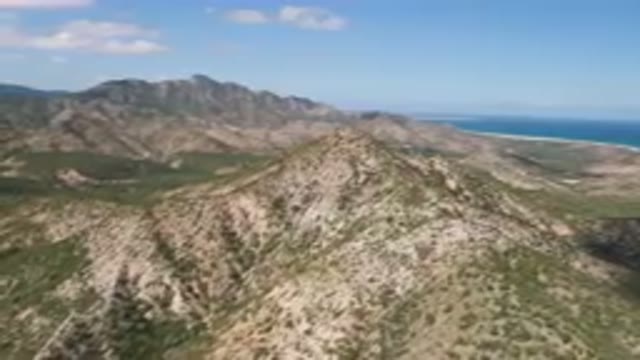 CABO PULMO BCS MEXICO-2023: Mountains With A Few Trees And A Body Of Water In