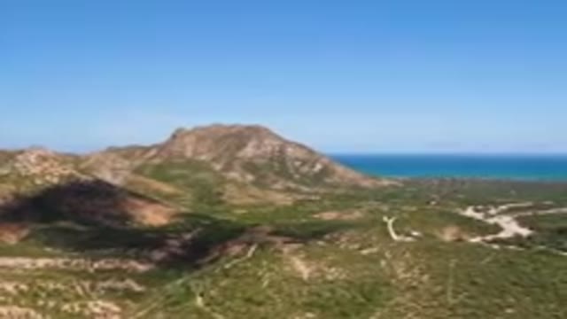 CABO PULMO BCS MEXICO-2023: Mountain Range With A Blue Ocean In The Background