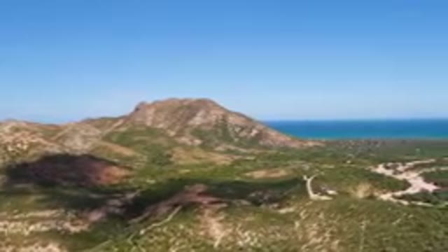 CABO PULMO BCS MEXICO-2023: Mountain With A Road And A Body Of Water
