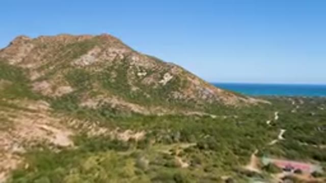 CABO PULMO BCS MEXICO-2023: Mountain With A Road Going Through It And A Body Of Water