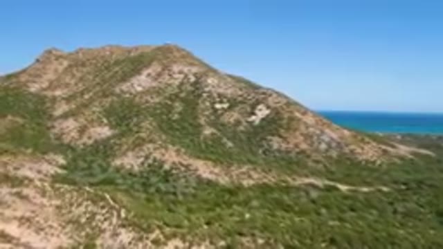 CABO PULMO BCS MEXICO-2023: Mountain With A Road Going Through It And A Body Of Water