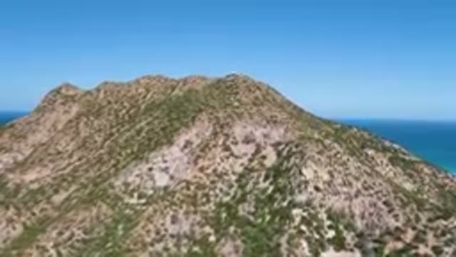 CABO PULMO BCS MEXICO-2023: Mountain With A Blue Sky And Ocean In The Background