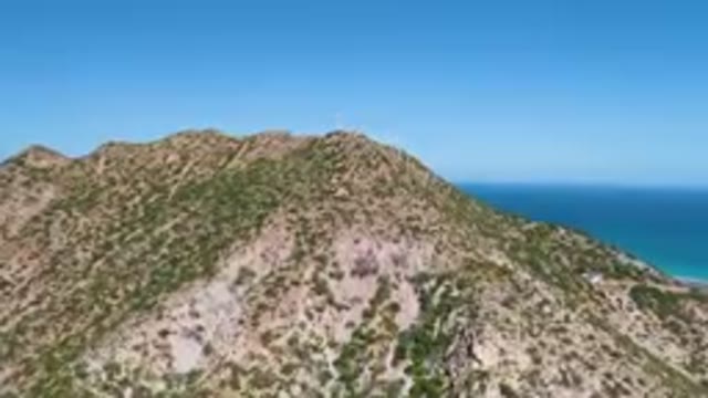 CABO PULMO BCS MEXICO-2023: Mountain With A Cross On Top Of It And A Blue Ocean