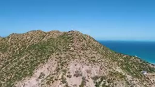CABO PULMO BCS MEXICO-2023: Mountain With A Small White House On Top Of It