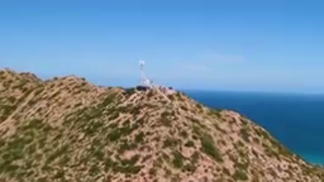 CABO PULMO BCS MEXICO-2023: Large Hill With A Tower On Top Of It