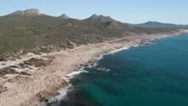 LAGUNA BEACH LOS CABOS BCS MEXICO-2023: Beach With A Road And A Mountain In The Background