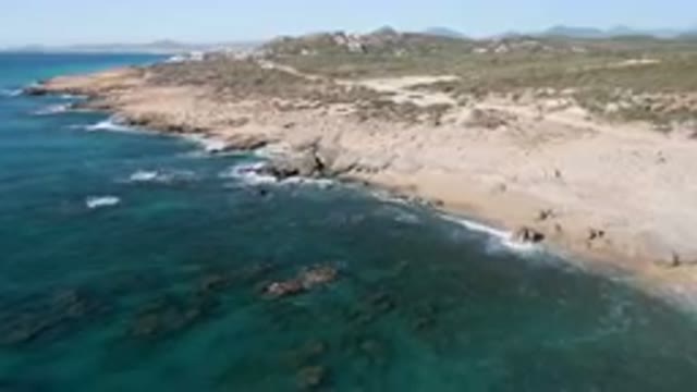 LAGUNA BEACH LOS CABOS BCS MEXICO-2023: Aerial View Of Rocky Shoreline With Ocean Waves