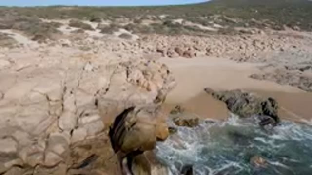 San Jose Del Cabo, Mexico-2023: Man on Rocky Ocean Cliff