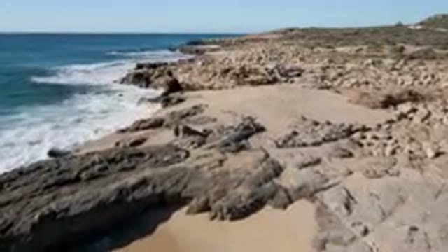 LAGUNA BEACH LOS CABOS BCS MEXICO-2023: Rocky Beach With Waves And Scattered Rocks