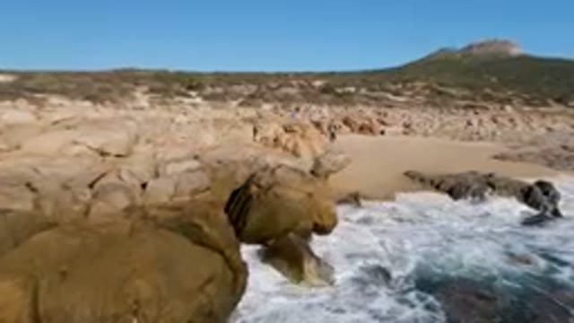 LAGUNA BEACH LOS CABOS BCS MEXICO-2023: Man Standing On A Rock By The Ocean