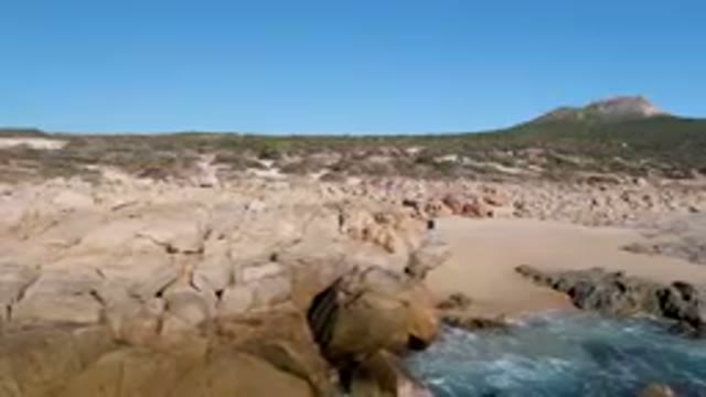 LAGUNA BEACH LOS CABOS BCS MEXICO-2023: Small Boat On Water Near Rocky Beach