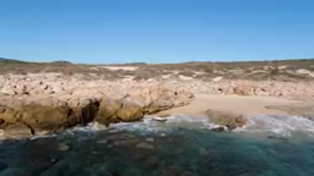 LAGUNA BEACH LOS CABOS BCS MEXICO-2023: Man Standing On A Rock By The Ocean