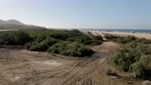 MIGRINO BCS MEXICO-2023: Dirt Road With Tracks In The Middle Of A Sandy Area