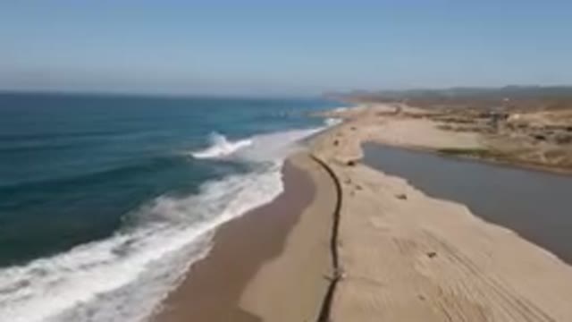 MIGRINO BCS MEXICO-2023: On The Beach With A Long Line Of People Walking Along