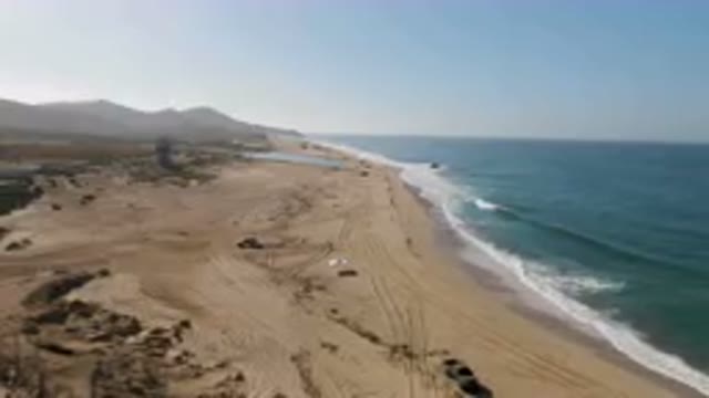 MIGRINO BCS MEXICO-2023: Truck Driving Down the Beach