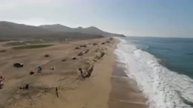 MIGRINO BCS MEXICO-2023: On The Beach With People And Umbrellas On The Sand