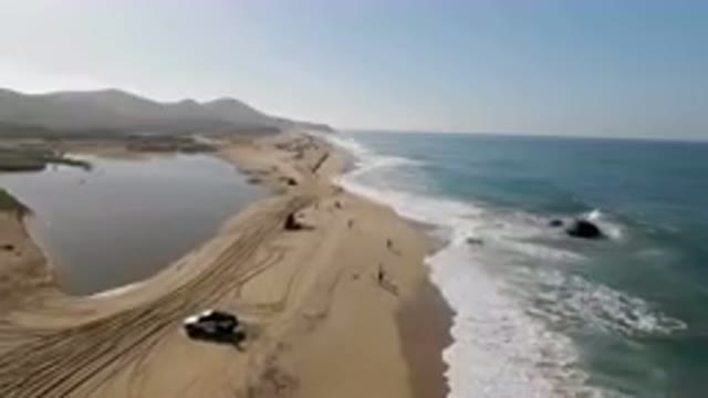 MIGRINO BCS MEXICO-2023: Aerial View Of Beach With Cars And People Walking On Sand