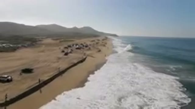 MIGRINO BCS MEXICO-2023: Many People Walking On The Beach Near The Water