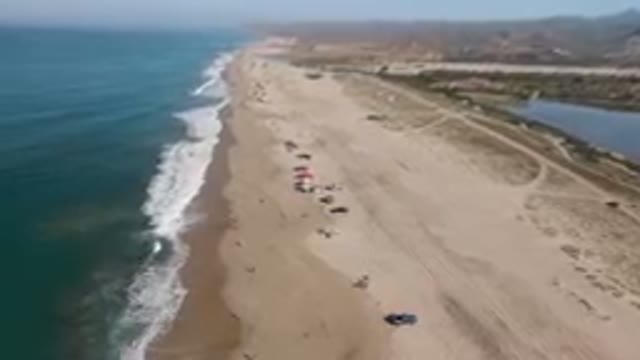 MIGRINO BCS MEXICO-2023: Aerial View Of Crowded Beach With People On Sand