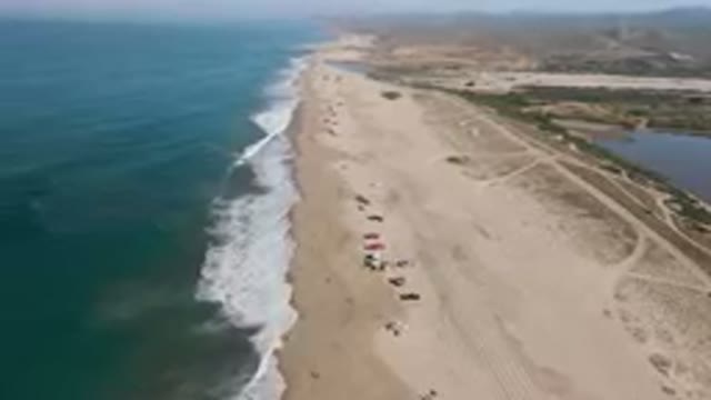MIGRINO BCS MEXICO-2023: Aerial View Of Crowded Beach With People On Sand