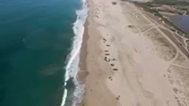 MIGRINO BCS MEXICO-2023: On The Beach With Umbrellas And People On The Sand