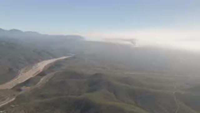 MIGRINO BCS MEXICO-2023: Mountains With A River Running Through Them And A Cloud