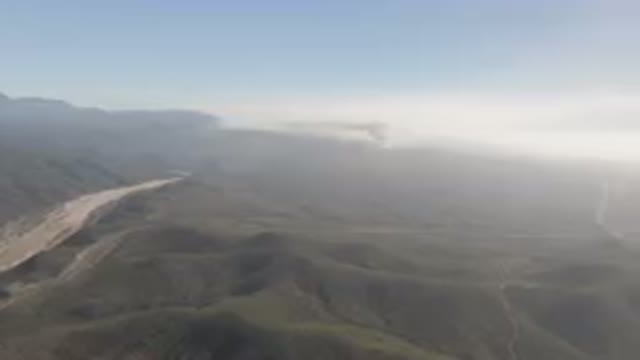 MIGRINO BCS MEXICO-2023: Mountains With A River Running Through Them And A Cloud