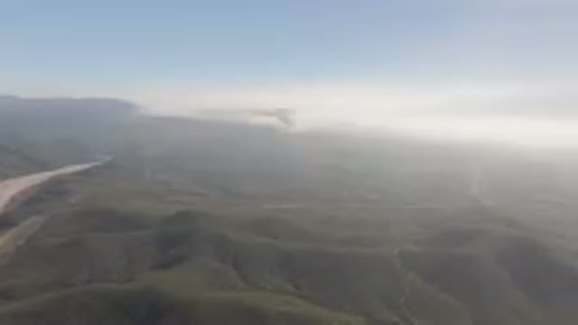 MIGRINO BCS MEXICO-2023: Mountains With A River Running Through Them And A Cloud