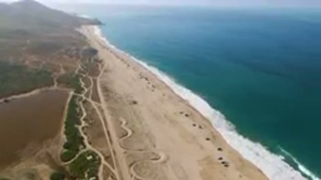 MIGRINO BCS MEXICO-2023: Aerial Beach With A Long Stretch Of Sand And A Body Of Water