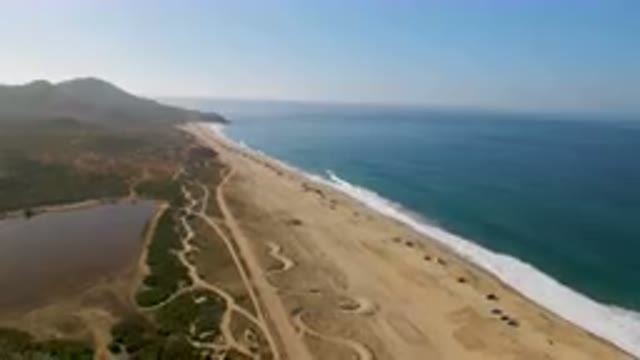 MIGRINO BCS MEXICO-2023: Aerial Beach With A Body Of Water And A Mountain