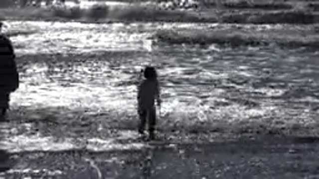 MALIBU CALIFORNIA-2020: Little Girl Jumping In The Sea While Her Mother Looks On