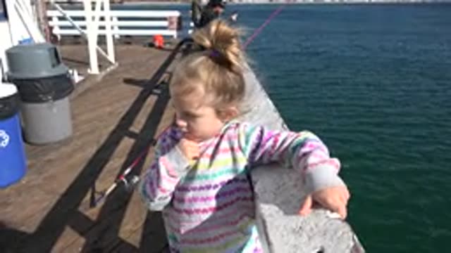 MALIBU CALIFORNIA-2020: Young Daughter Holding Onto Boat as Wind Blows