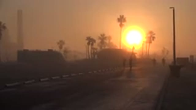 HUNTINGTON BEACH CALIFORNIA-2020: People Jog Towards Camera in Hazy Sunrise