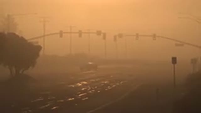 HUNTINGTON BEACH CALIFORNIA-2020: A Car Driving Down A Hazy Dusty Street At