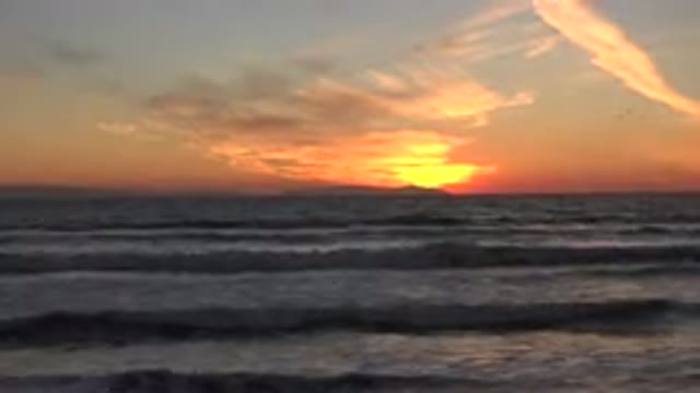 HUNTINGTON BEACH CALIFORNIA-2020: Pretty Orange Sky Bright Yellow Sun Clouds In