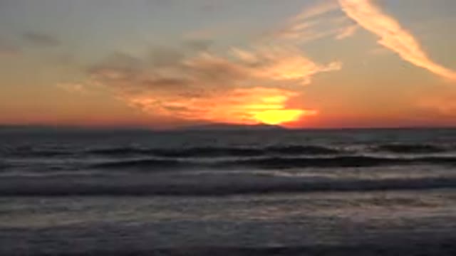 HUNTINGTON BEACH CALIFORNIA-2020: Waves Crashing Onto The Shore As The Sunset