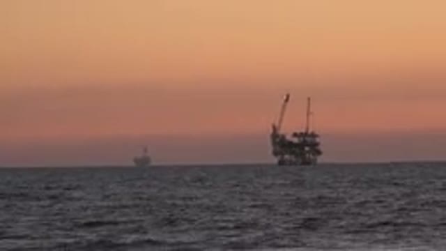 HUNTINGTON BEACH CALIFORNIA-2020: A Red Sunset Over The Ocean With Boats In Distance